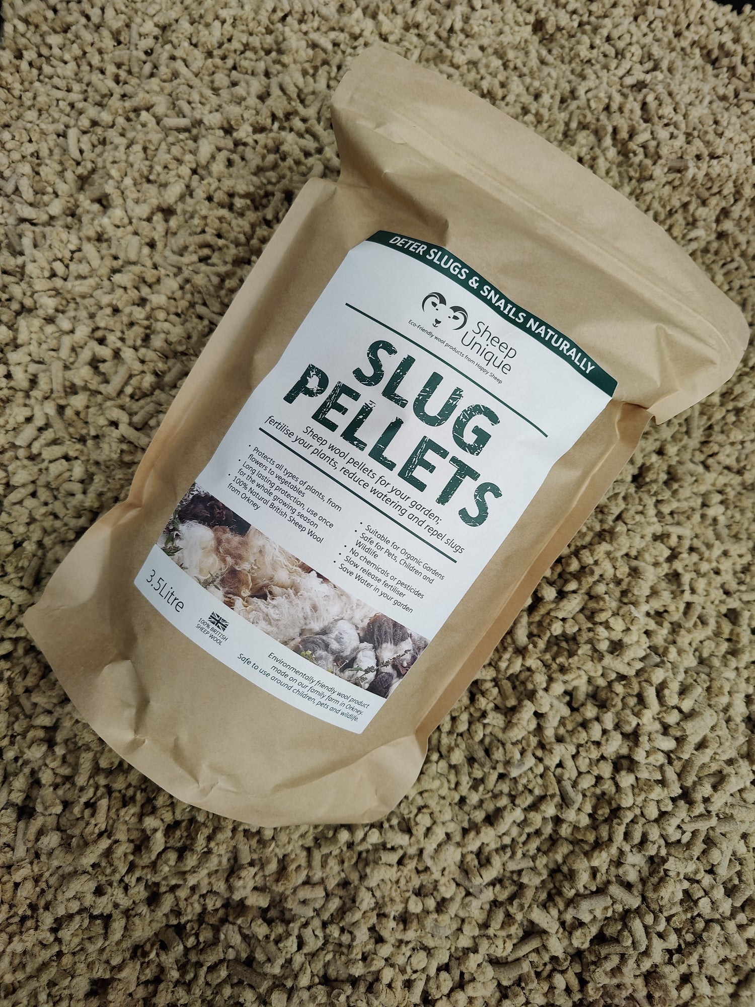 Photo of a bag of slug pellets resting on a shed load of pellets